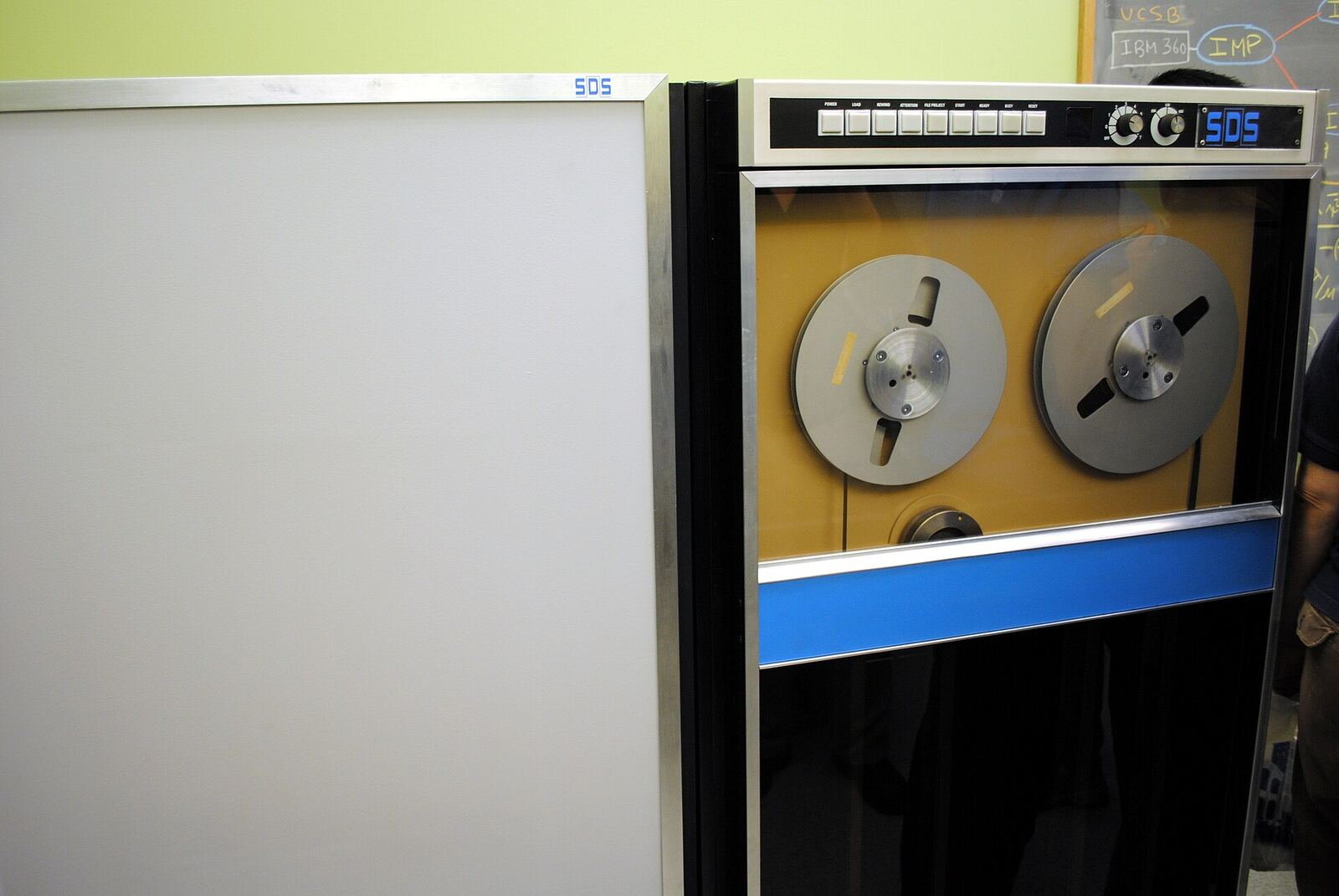 A vintage computer with magnetic tape reels represents the first machine connected to the ARPANET, a precursor to the.