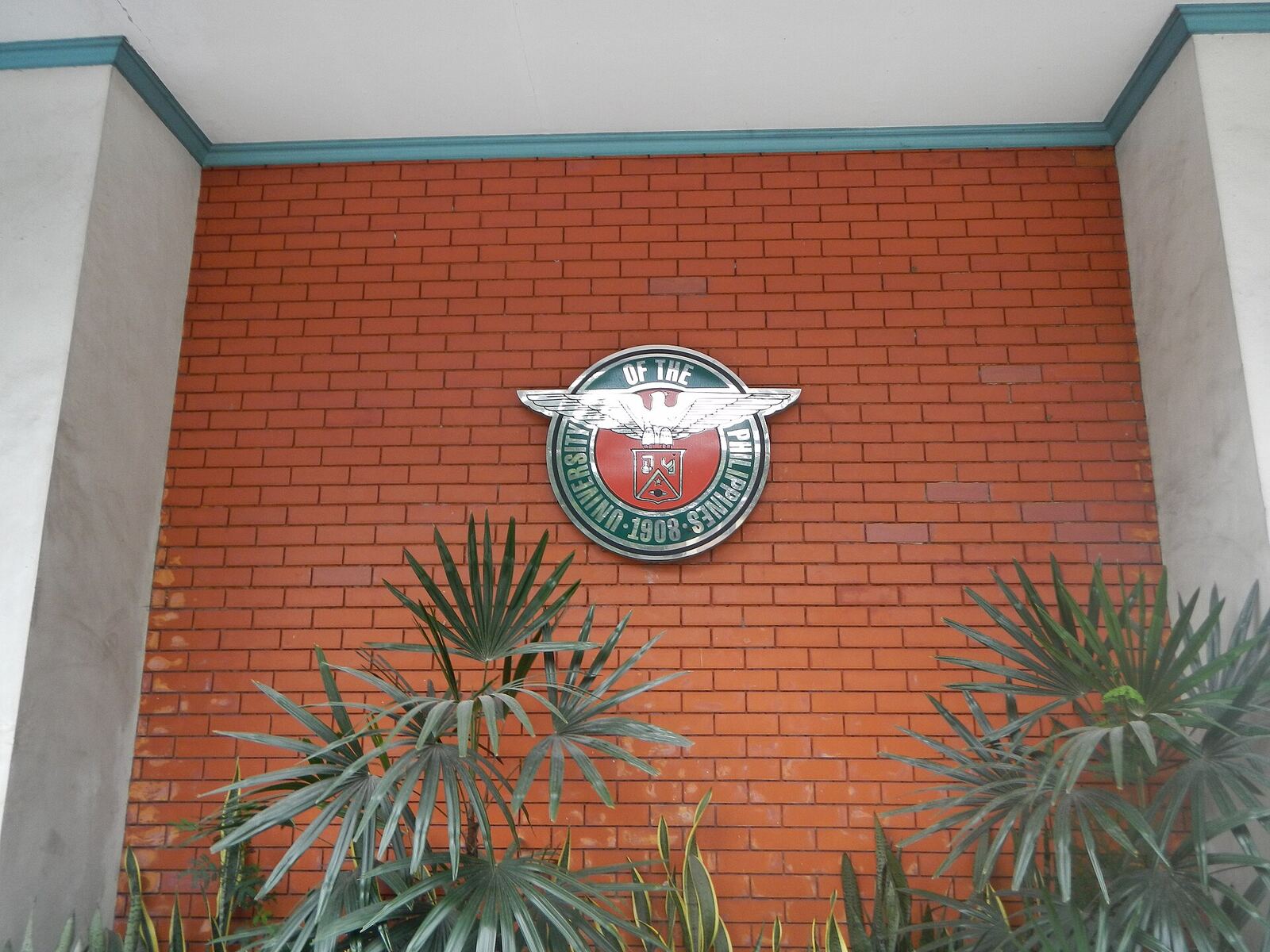 University of the Philippines | Life of Internet The University of the Philippines Diliman emblem is visible on a brick wall, showcasing architectural details and digital.
