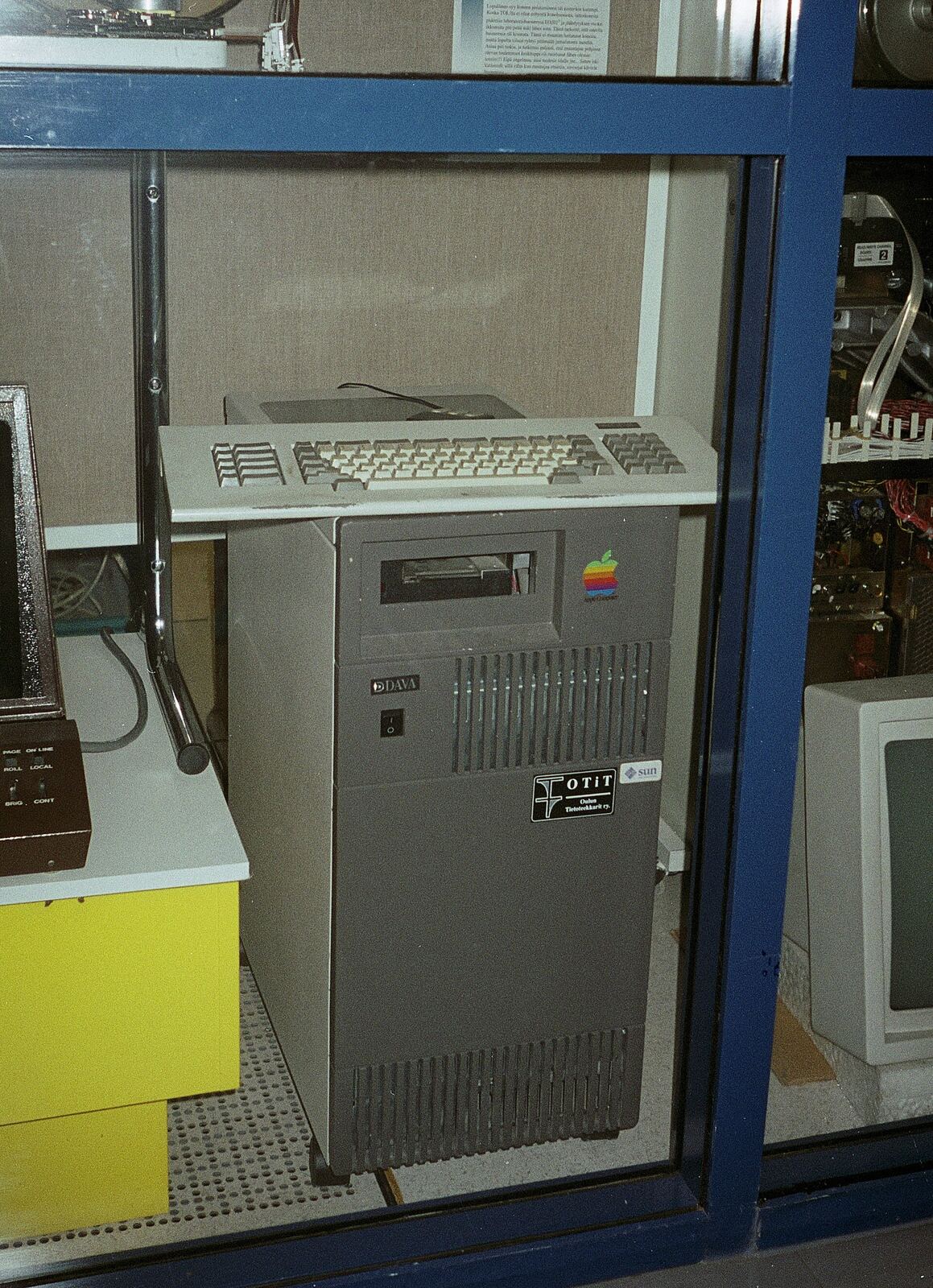 A vintage Apple Macintosh computer is displayed, representing early personal computing and the history of technology.